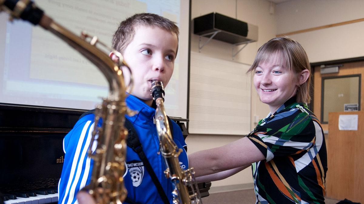 Student giving saxophone lessons
